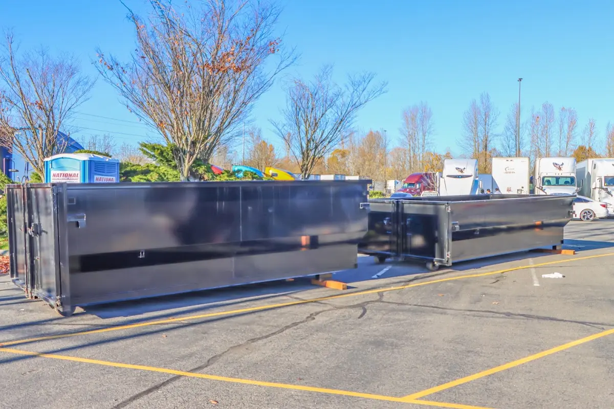 Professional dumpster rental service with roll-off container on residential driveway in Wilkinsburg